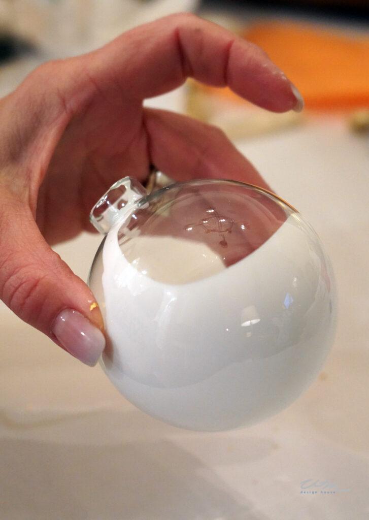 pouring paint inside of glass ornaments