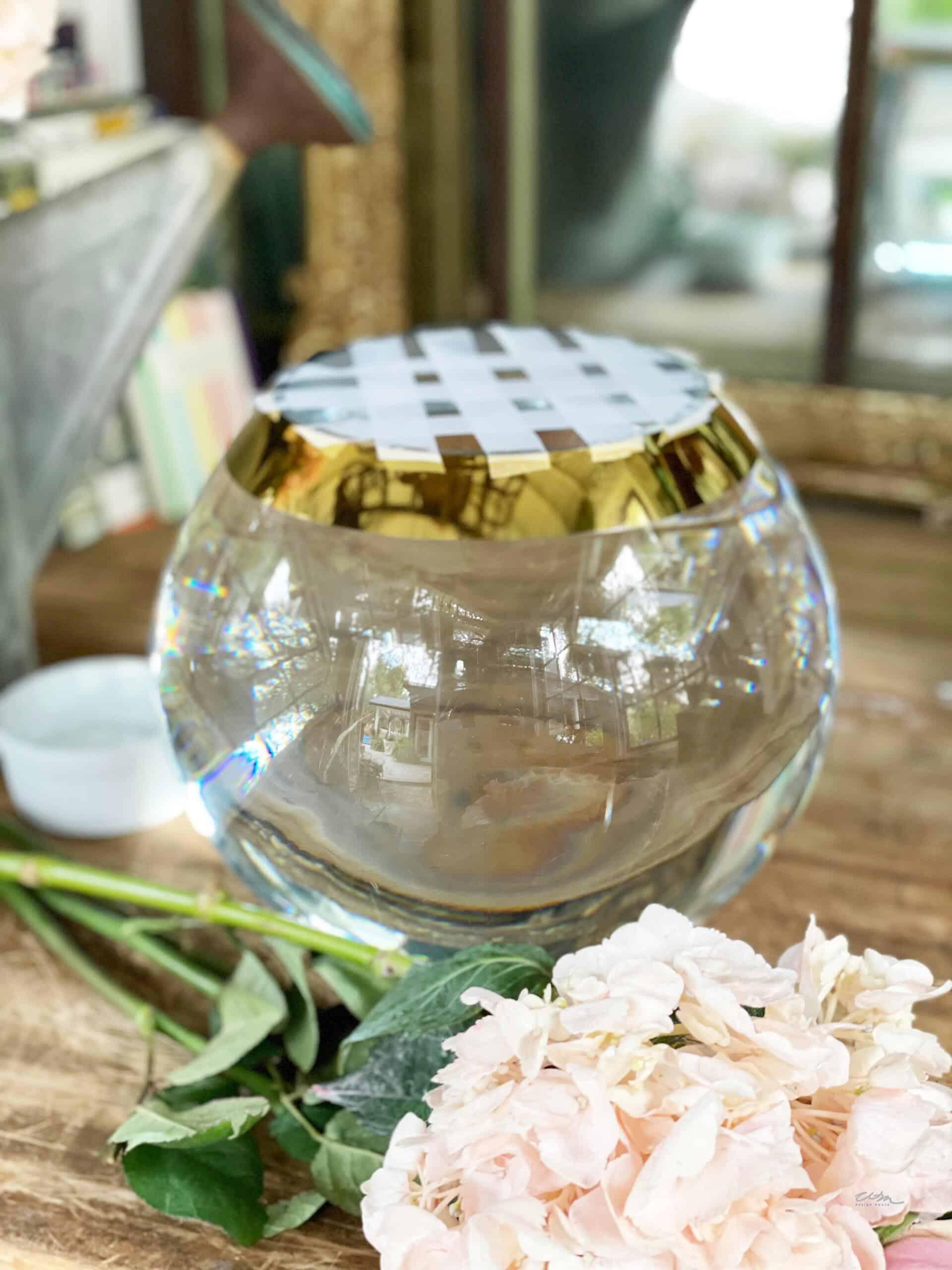 small clear round glass vase with a tape grid for floral arrangements