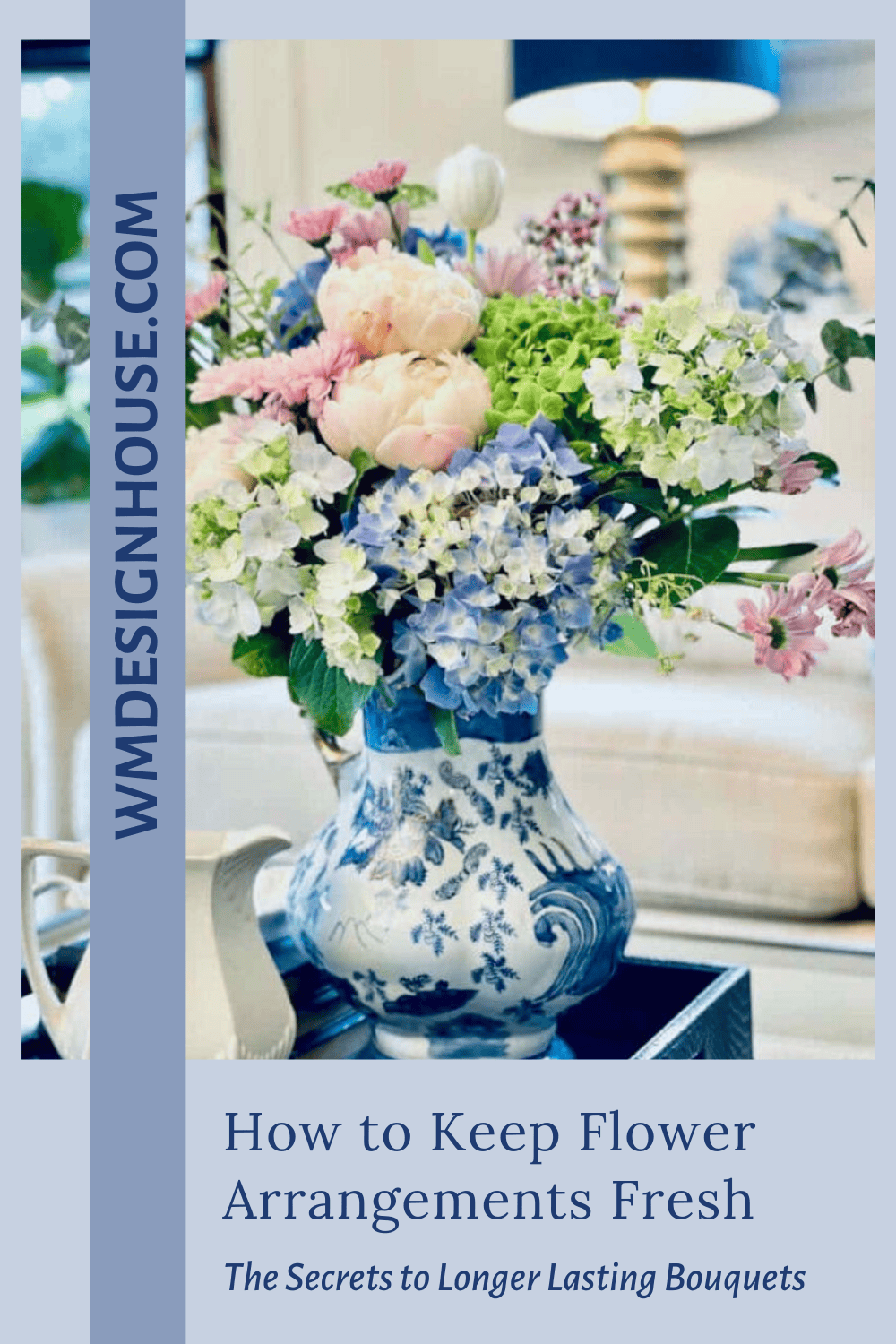 A blue and white vase holds a fresh bouquet of pink, white, and blue flowers on a table, with "How to Keep Flower Arrangements Fresh" and "WMDesignHouse.com" displayed—perfect inspiration for those wanting tips on how to keep flower arrangements fresh.