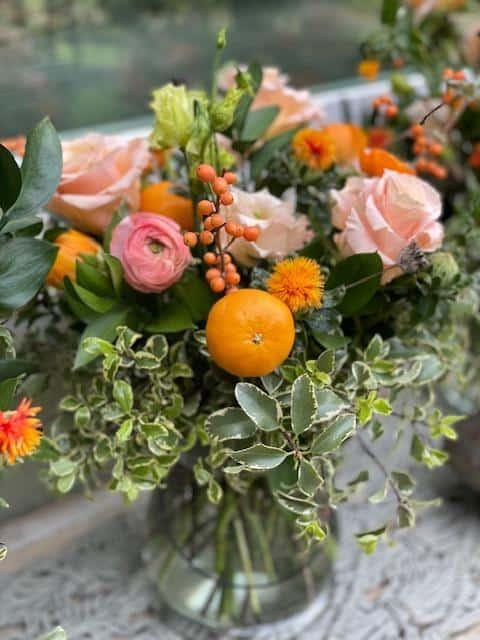 Arrangement made with fresh flowers and little cutie oranges 