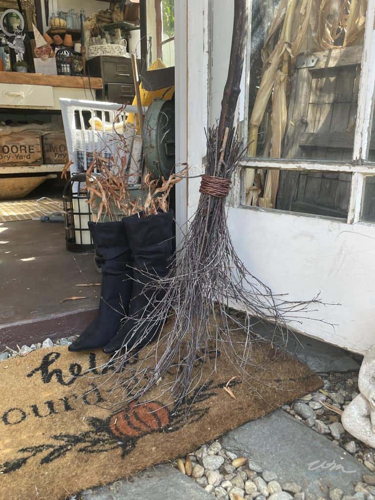 DIY witch's broom DIY Halloween decor ideas with a fall doormat and some black boots to create a display