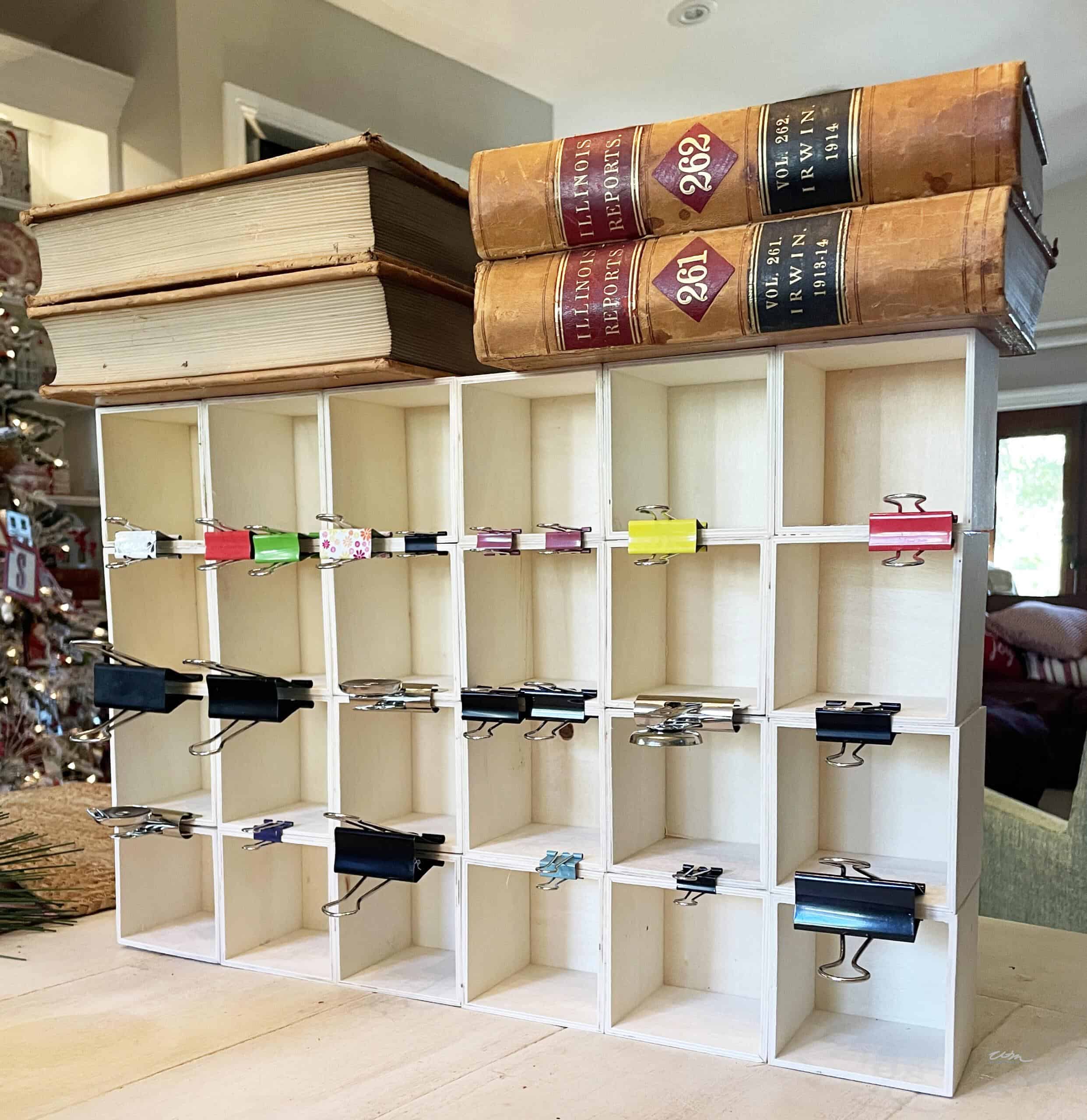 Placing books on top of DIY advent calendar to keep the frame together while it dries