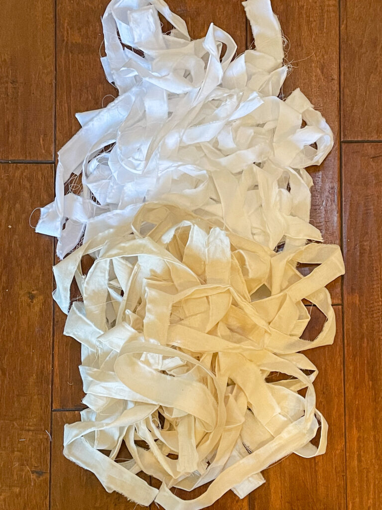 To start making your Valentine's Day wreath, prepare fabric by tearing the muslin into strips.