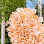 Adding a carrot top to my DIY carrot wreath made with carrot-dyed fabric strips, similar to a rag wreath.