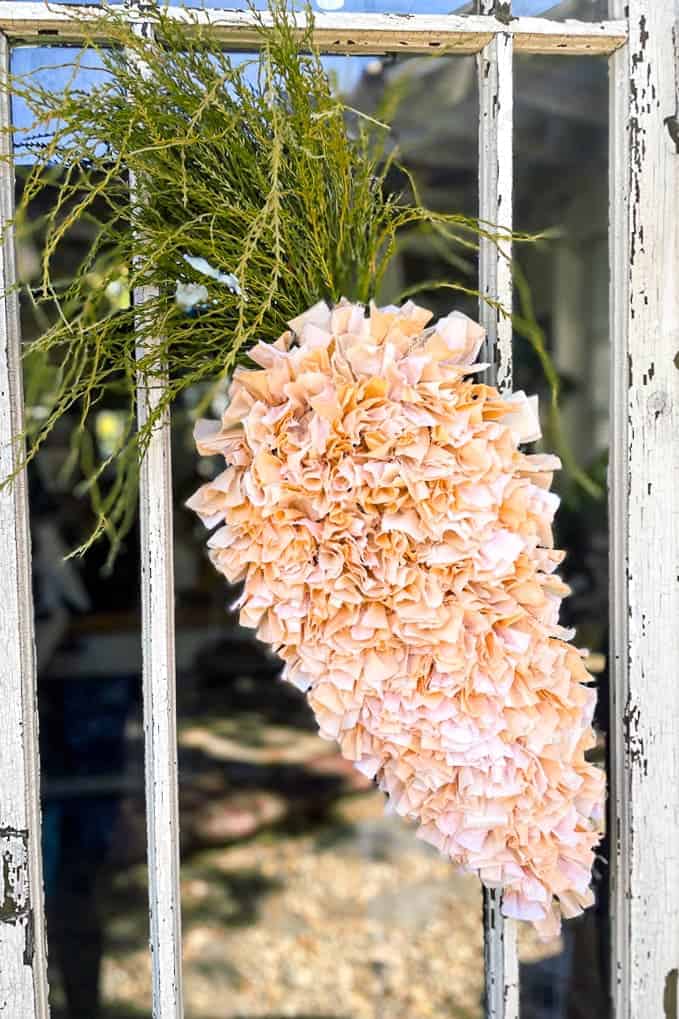 Carrot-dyed DIY Fabric rag wreath hanging on a door. 