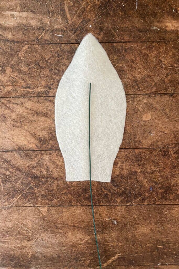 Felt cut out in the shape of a bunny ear and glued to a piece of wire.