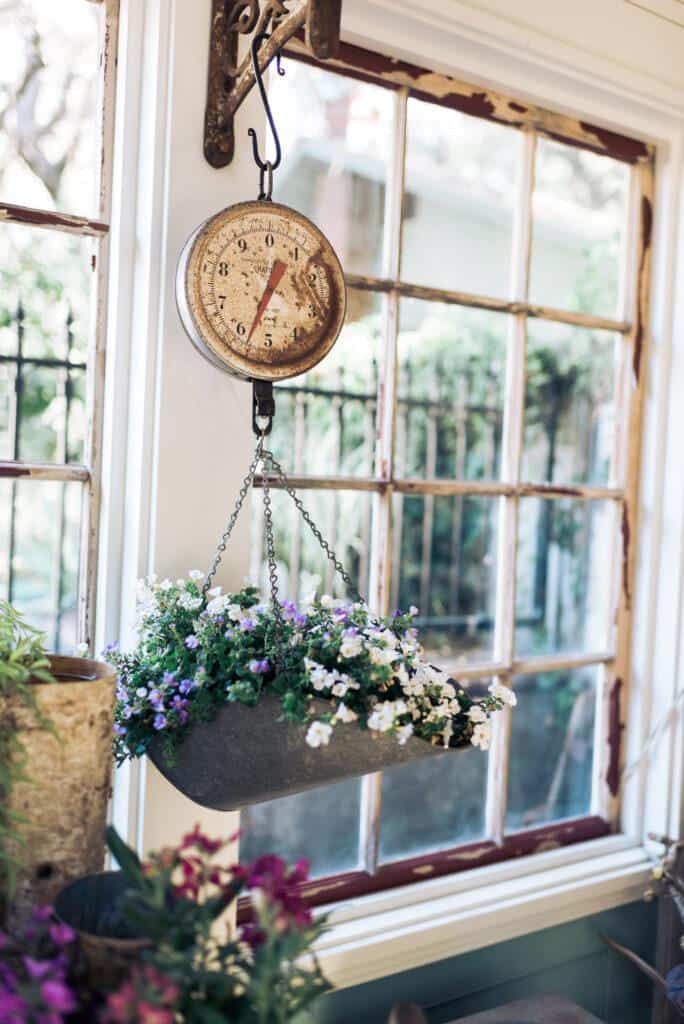 vintage scale that hangs and holds flowers