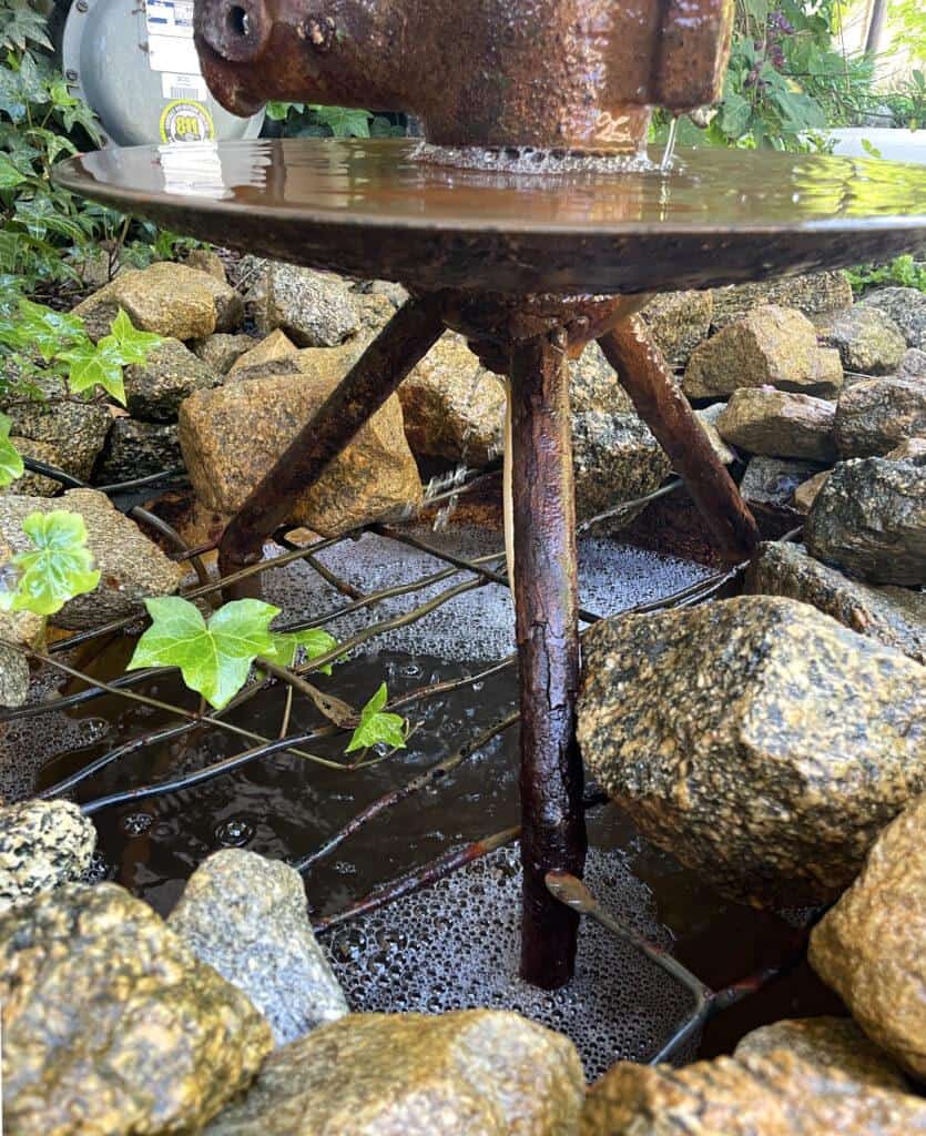 base of antique farm disc water fountain