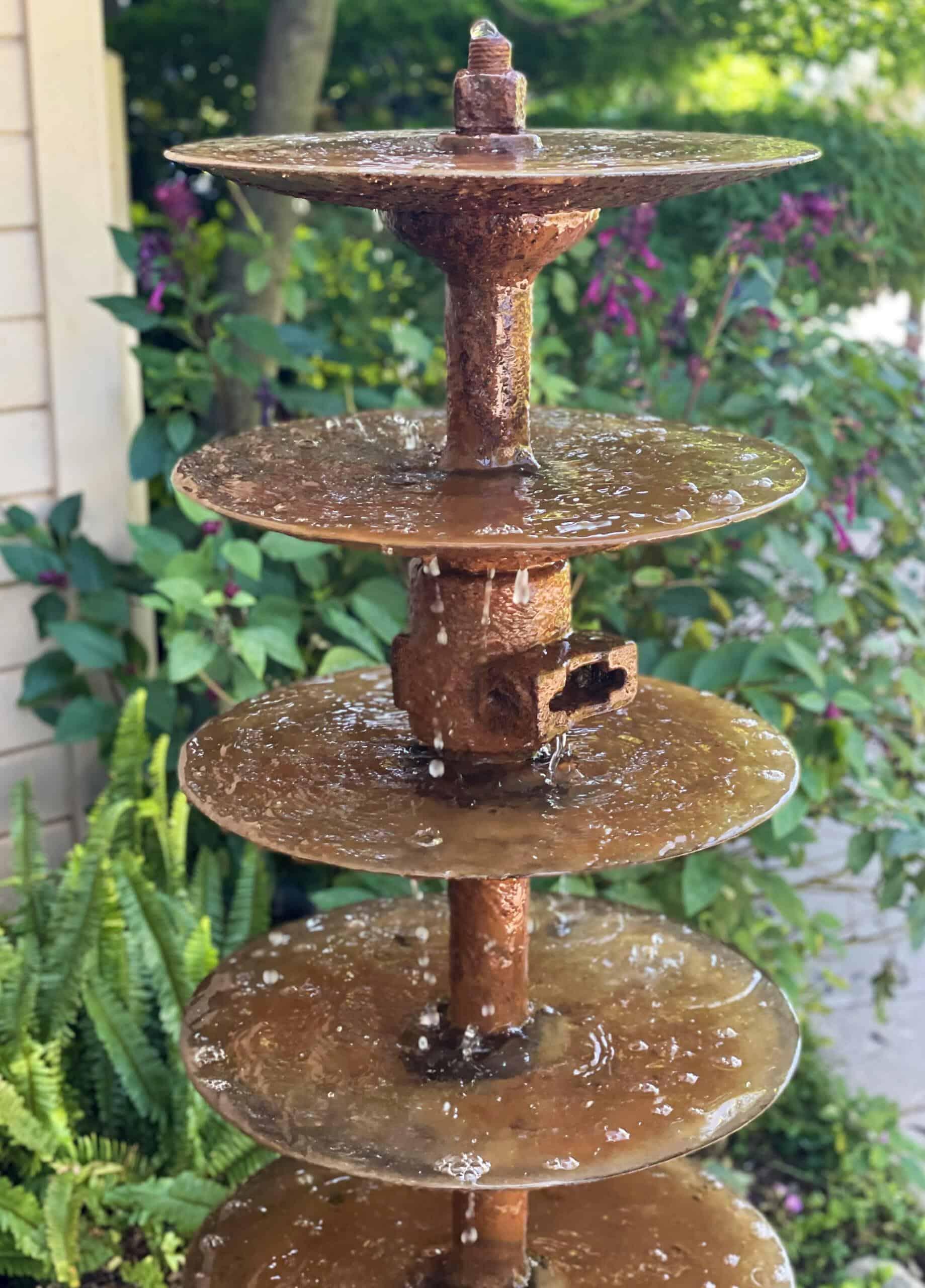 antique farm disc water fountain