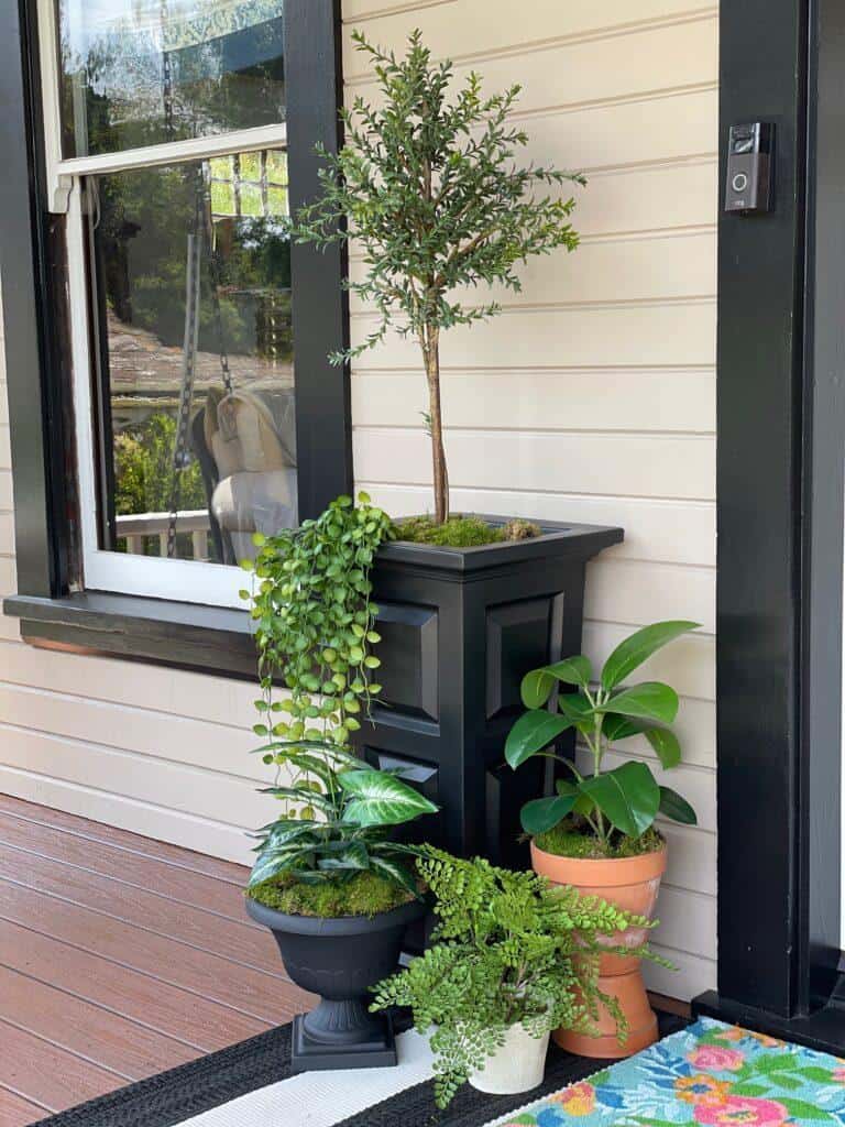 Bring a touch of nature to your porch by adding in potted plants or other greenery
