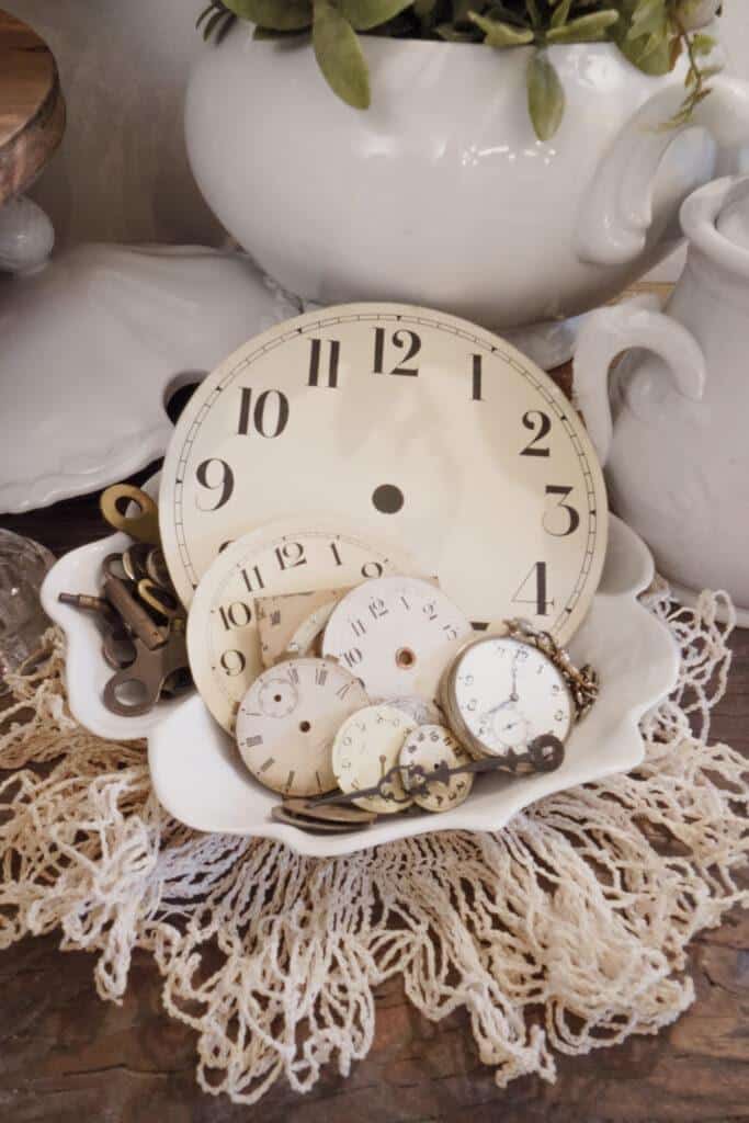 collection of white ironstone and vintage clock faces