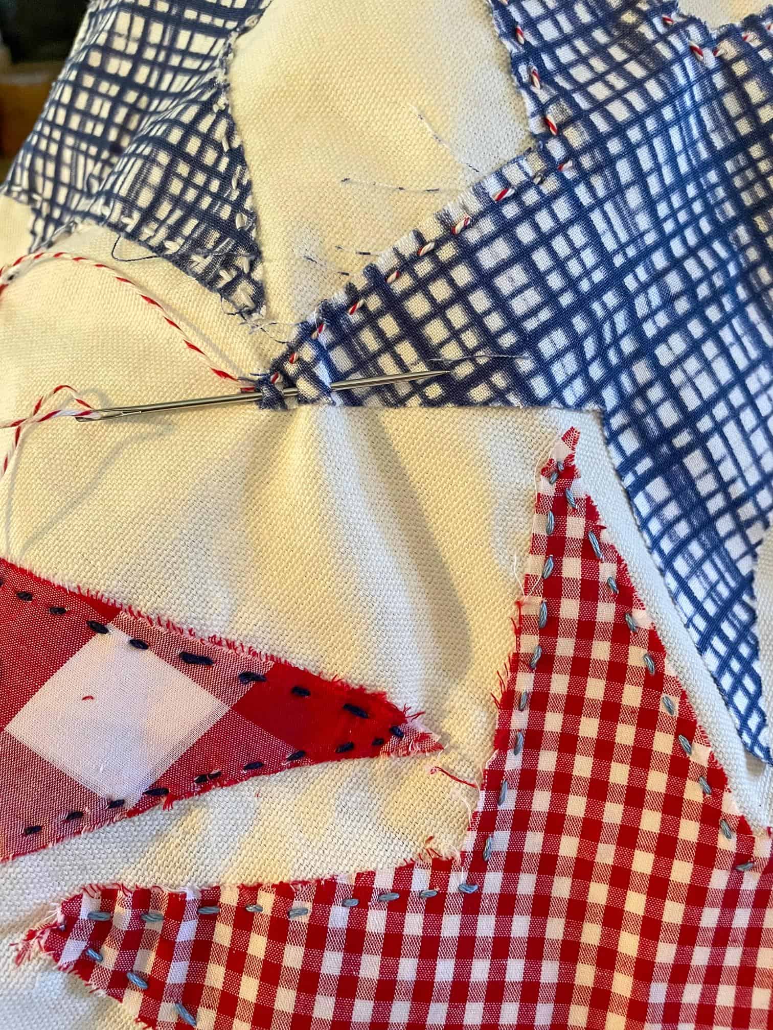stitching on fabric stars for a DIY throw pillow for fourth of July 