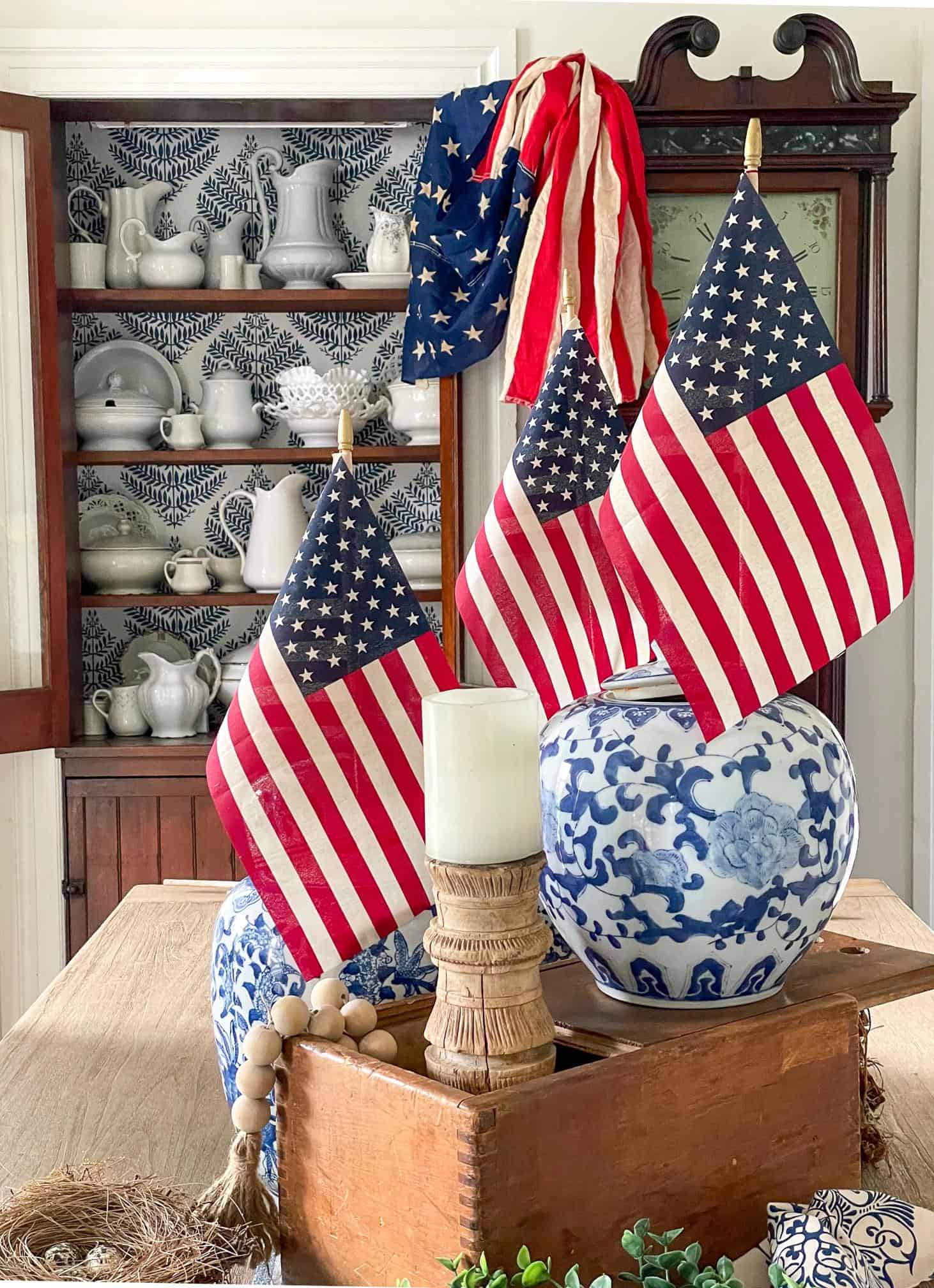 American flags in blue and white vases decorating the table 