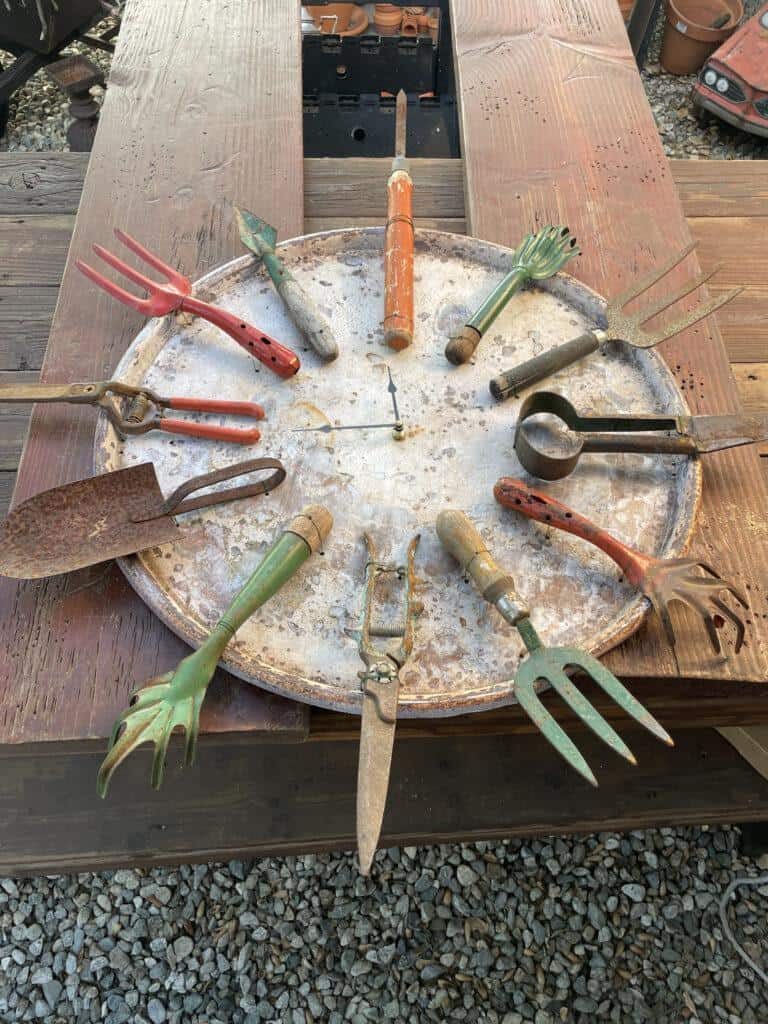 Then, attach the garden tools around the clock face