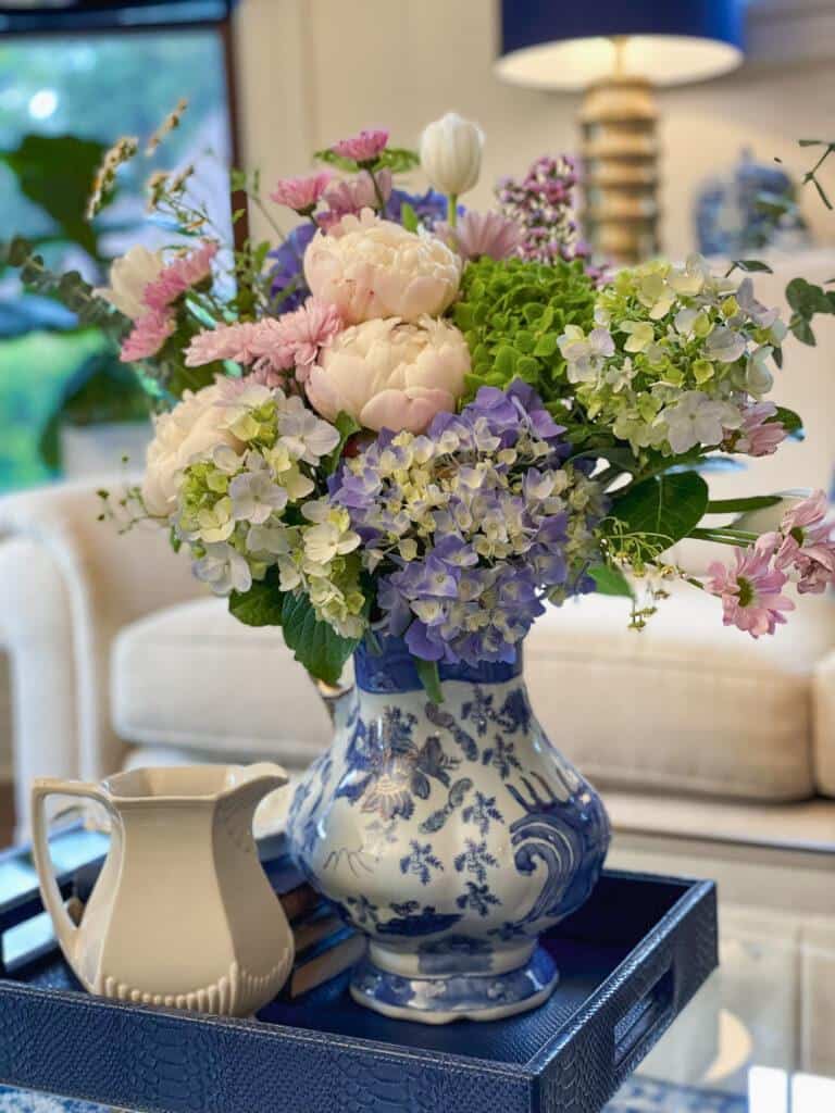 Fresh flowers with peonies in the living room for summer decorating 