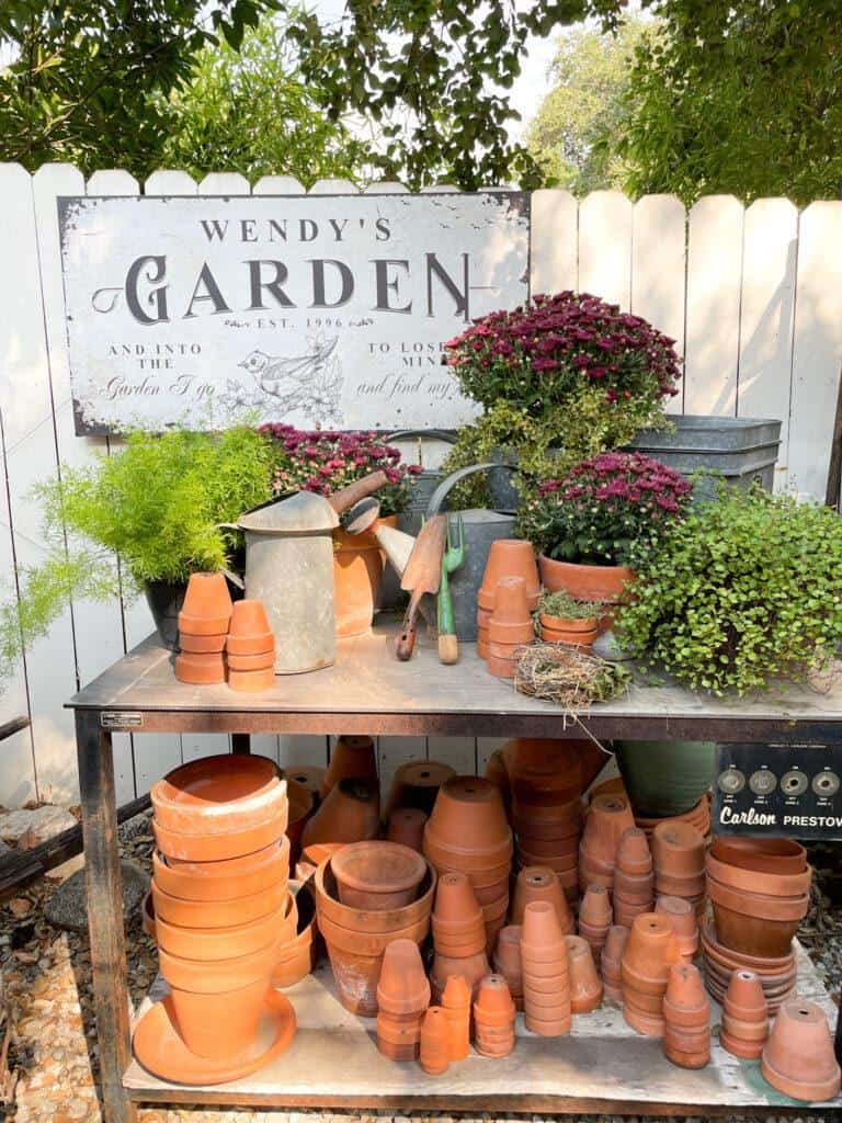 garden bench covered with aged terracotta pots