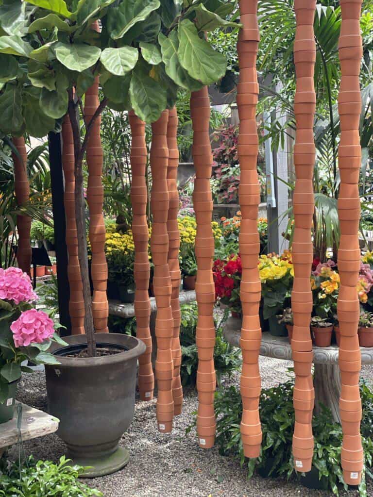 decorative garden wall made from stacked terra cotta pots