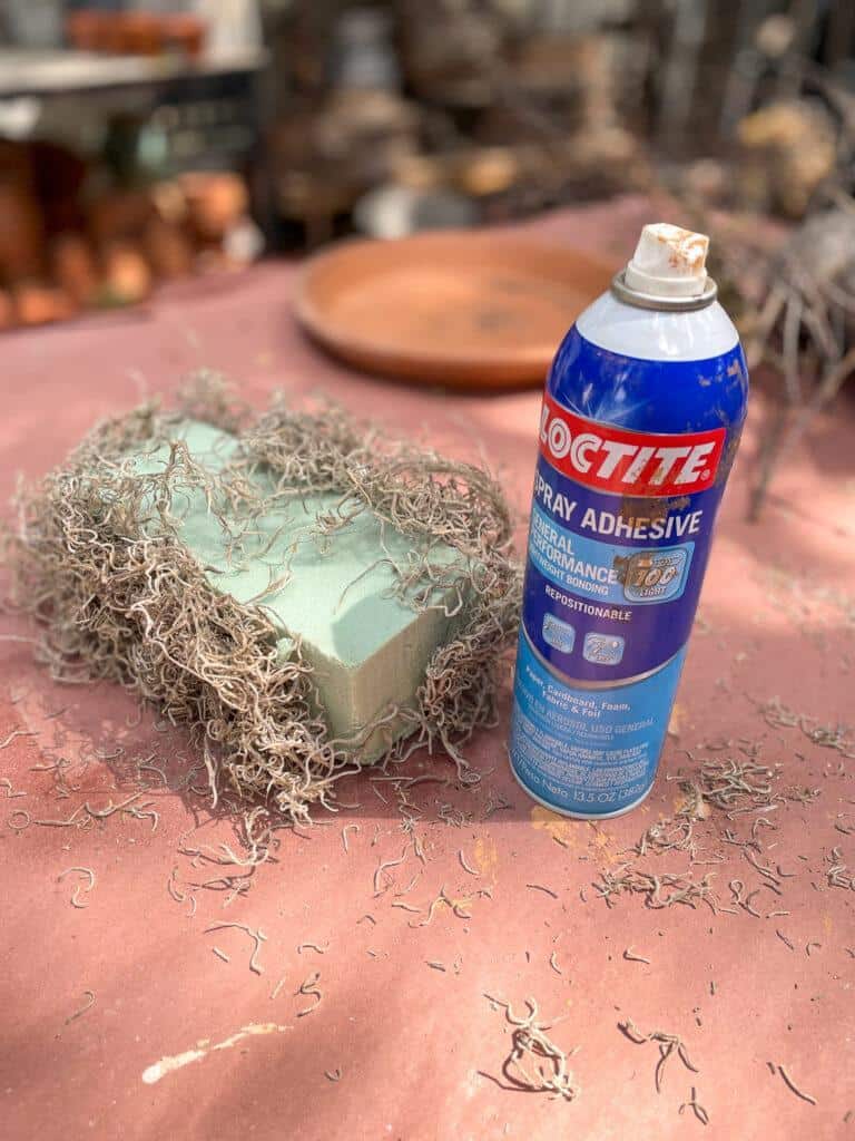 use spray glue to cover foam floral blocks with spanish moss
