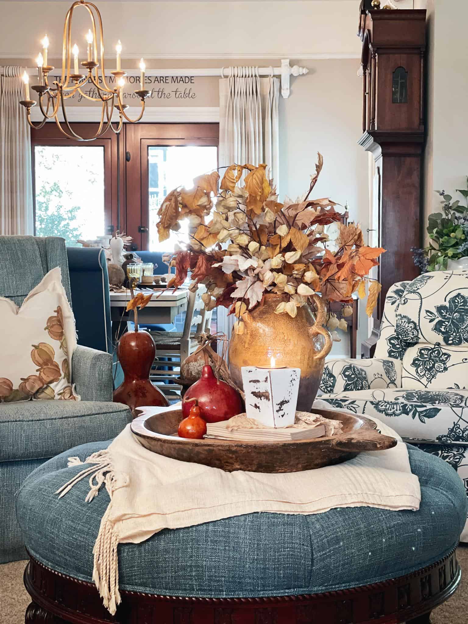 DIY stamped throw pillow styled on a chair in the family room 