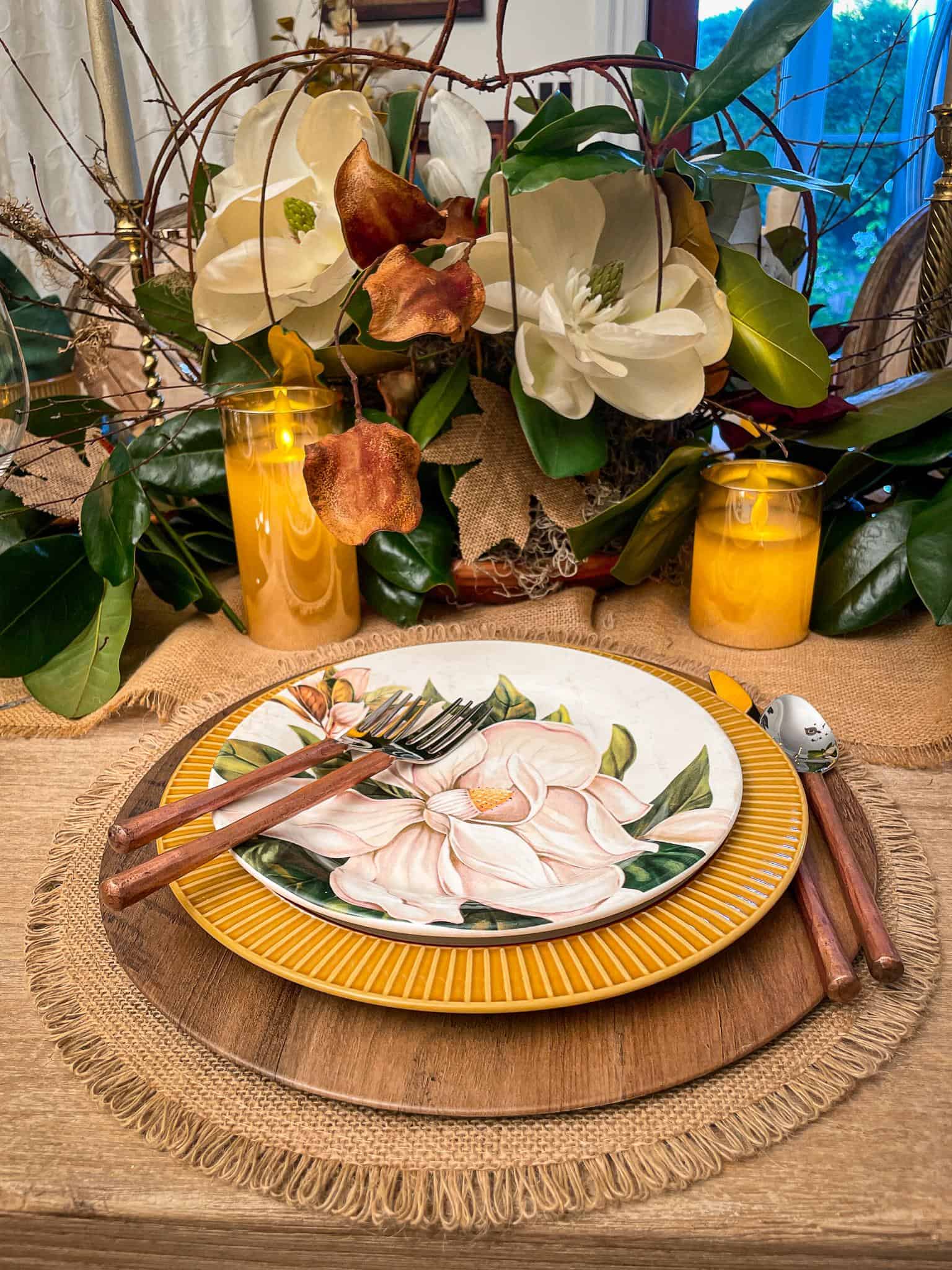 rustic place setting with wooden charger and magnolia dishes for a fall tablescape