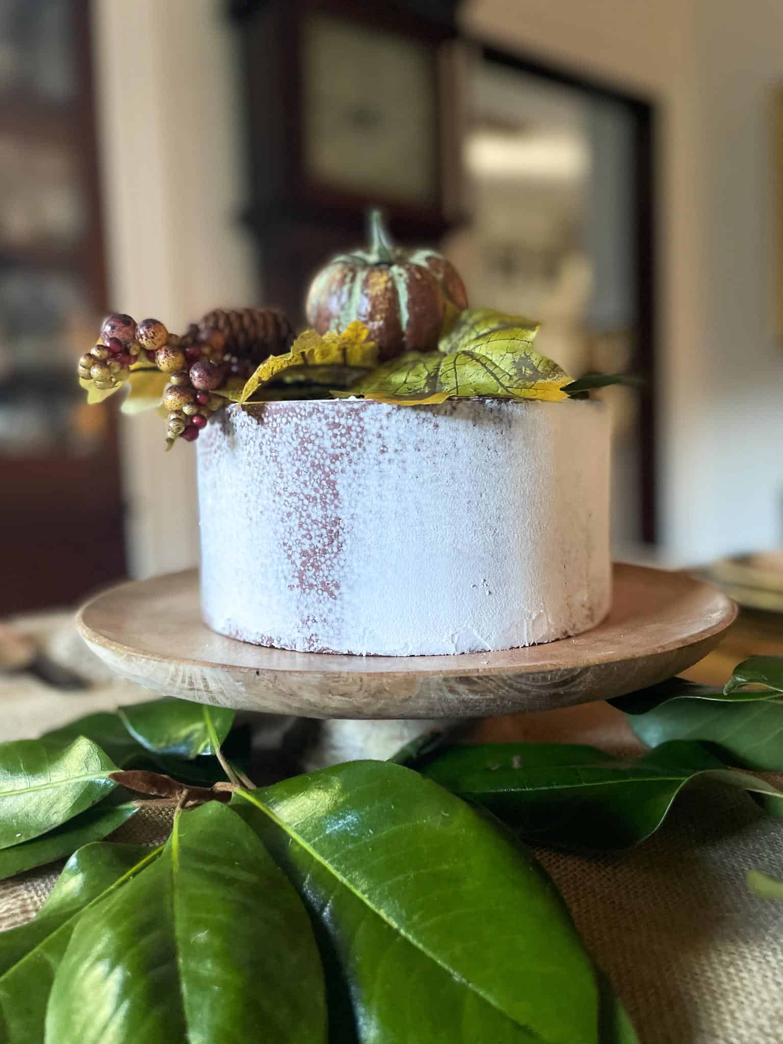 wooden cake stand with rustic cake for fall table