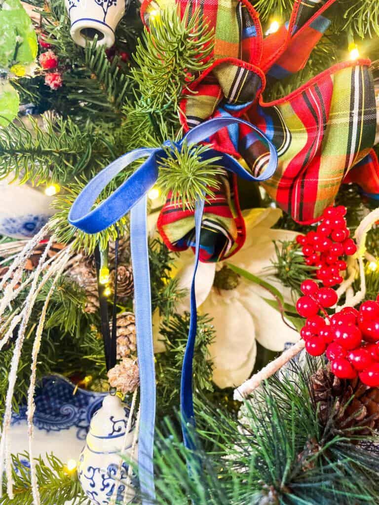 Skinny blue velvet ribbon on blue and white christmas tree 