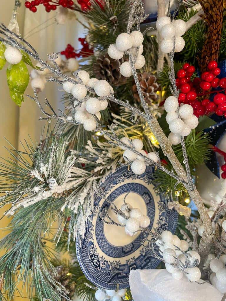 Spring with white berries on the blue and white christmas tree 
