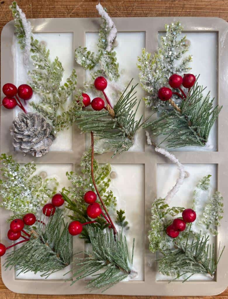 Scented wax sachets with faux greenery and berries to use as packaging decorations.