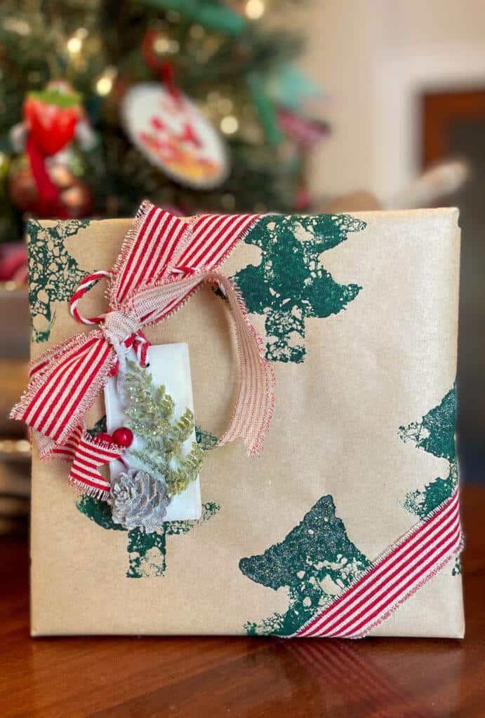 Christmas gift with a wax sachet tag on the front with striped ribbon.