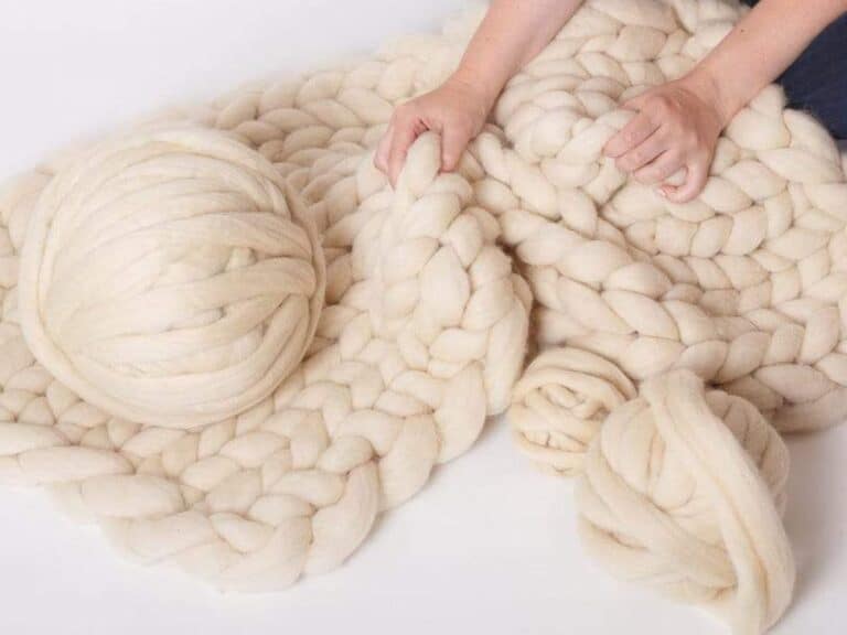 Wool chunky knit yarn being woven into a blanket