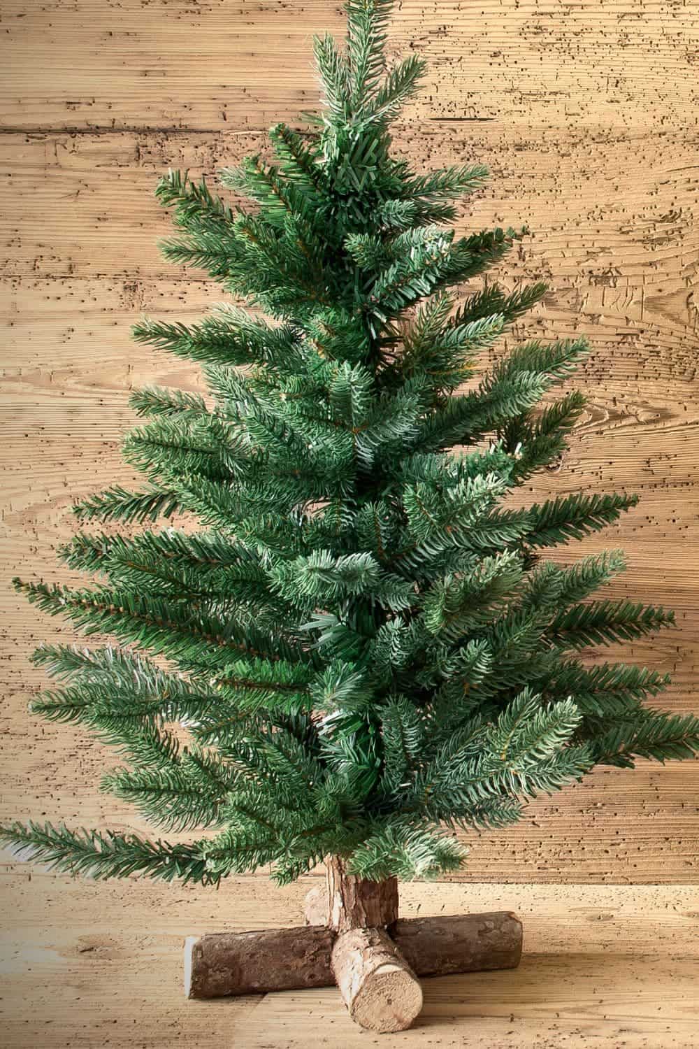 A Christmas tree was placed into a log as a stand. 