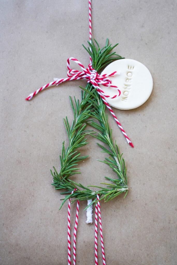 Christmas tree out of rosemary on kraft paper gift