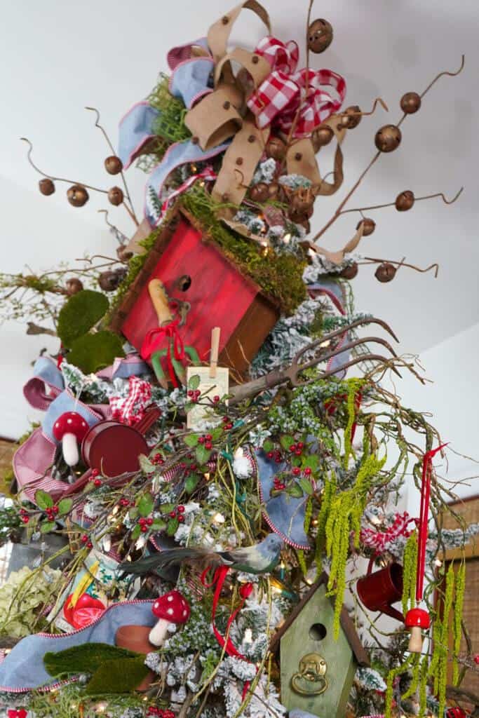 Birdhouse on top of Christmas tree with a unique artificial christmas tree stand 