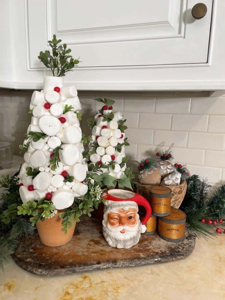 Small white marshmallow Christmas trees next to the stove 