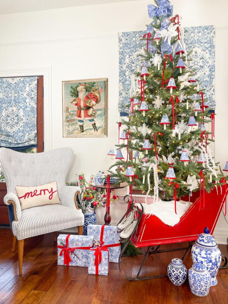 king of christmas tree decorated in a red sleigh 