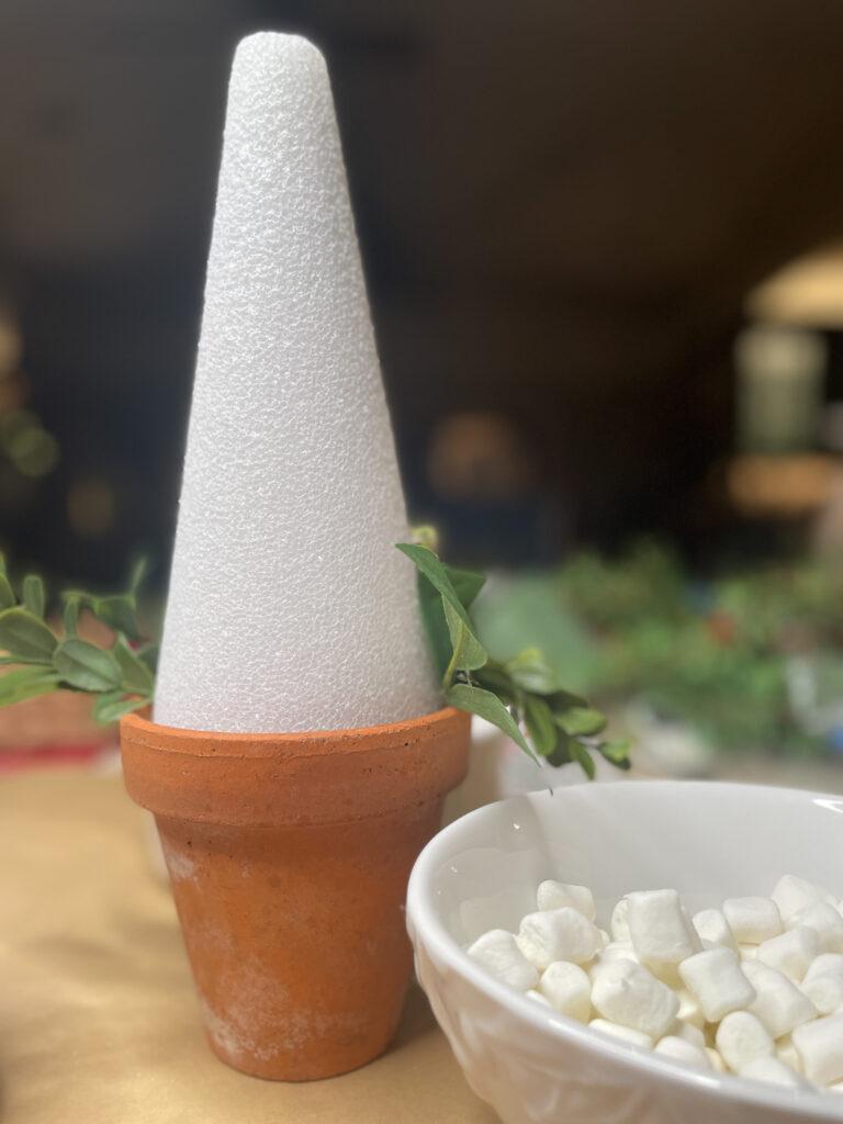 Styrofoam cone inside of a clay pot to make marshmallow Christmas trees