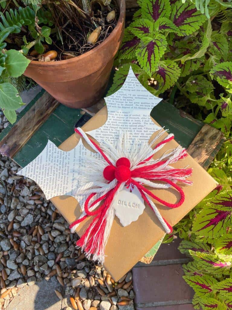 Kraft paper gift with string and book page holly leaves 