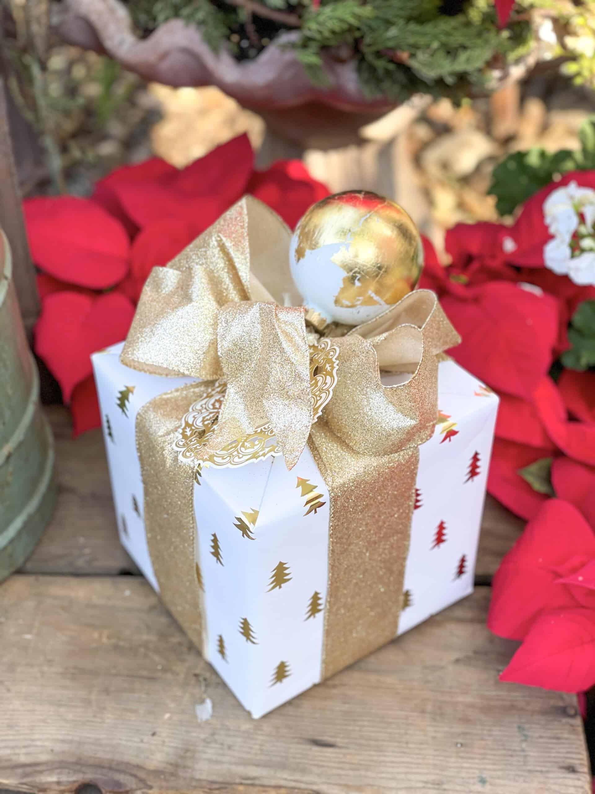 Gold leaf ornaments attached to a Christmas gift