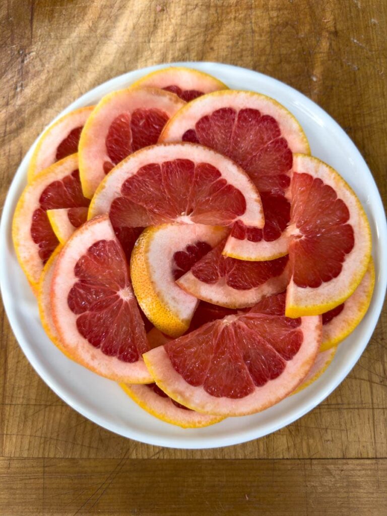 Grapefruit half slices on a plate.