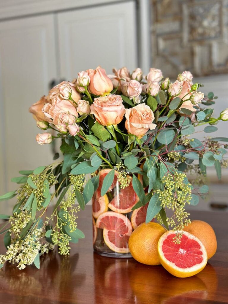 Flower arrangement in a vase with grapefruit