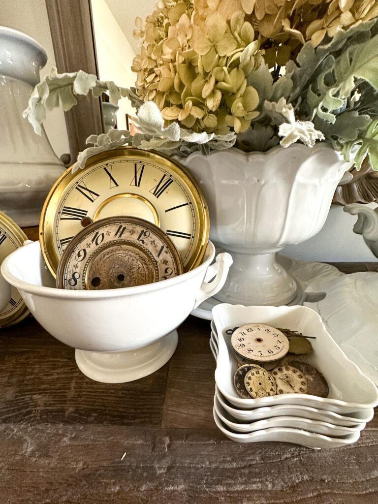 White ironstone collection used for winter decorating with old clock faces