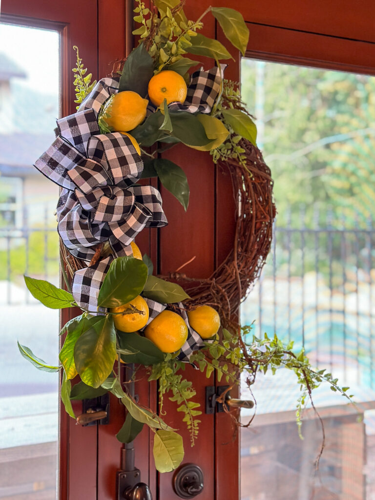 Fresh Lemon wreath hanging on a door inside of the house 