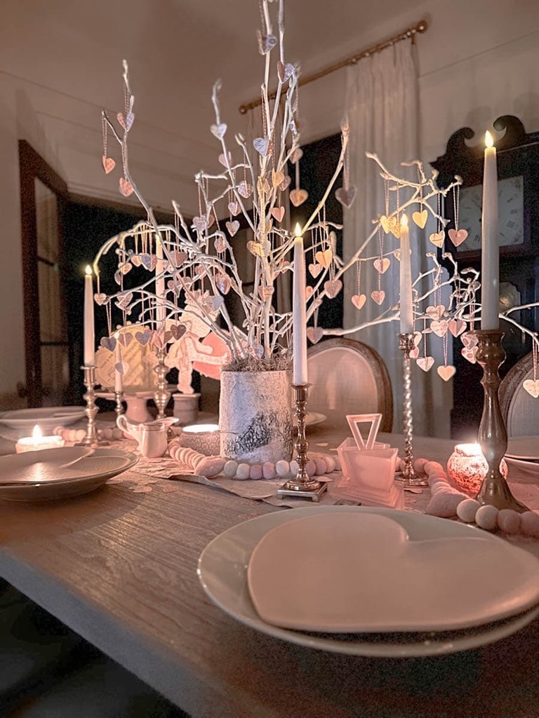 Dining table set for Valentine's Day with tree centerpiece