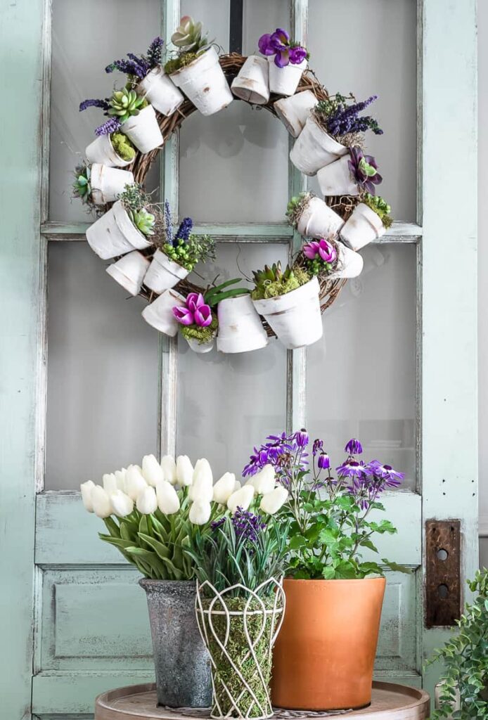 Spring wreath made out of white terra cotta pots and flowers for spring decor 
