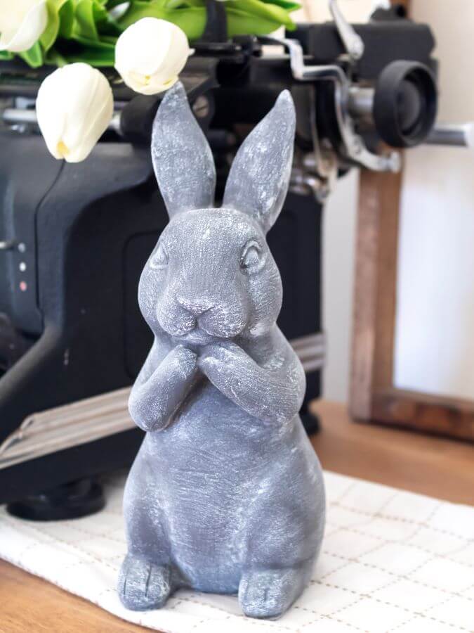 A cement bunny rabbit for spring decor 