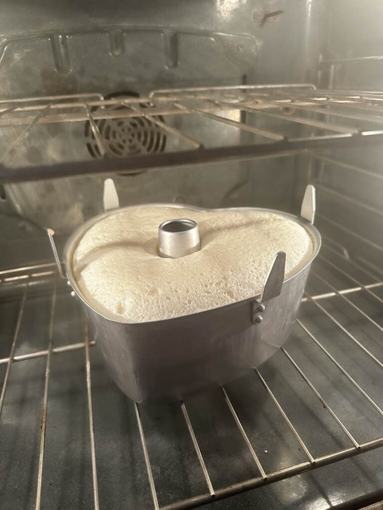 Cake rising in a pan in the oven 