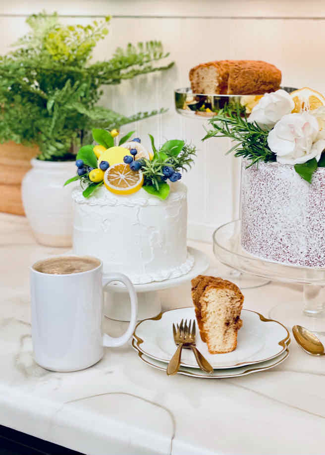 Desert bar with white cakes and yellow decorations with coffee