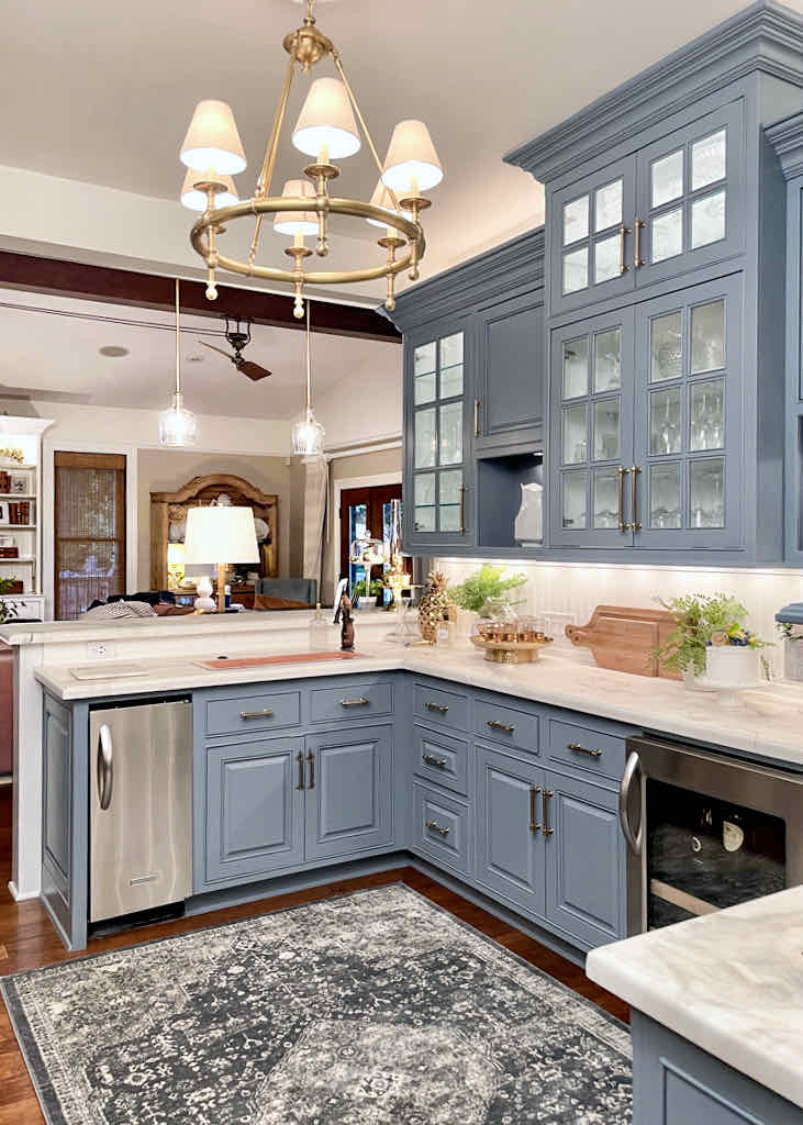 butlers pantry with blue cabinets and white countertops 