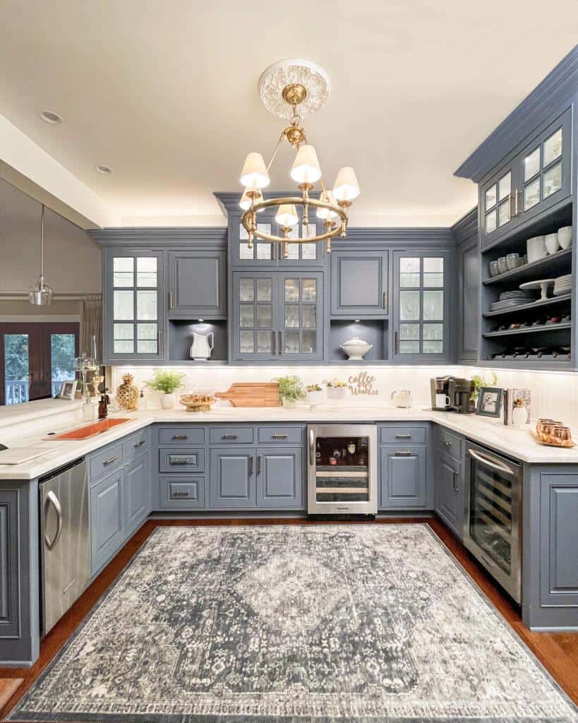 Butlers pantry with blue cabinets and white beadboard backsplash and marble countertops 