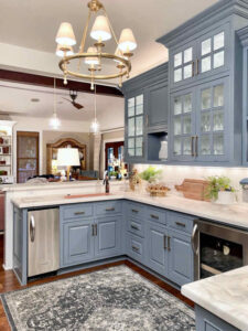 butlers pantry with blue cabinets and white countertops